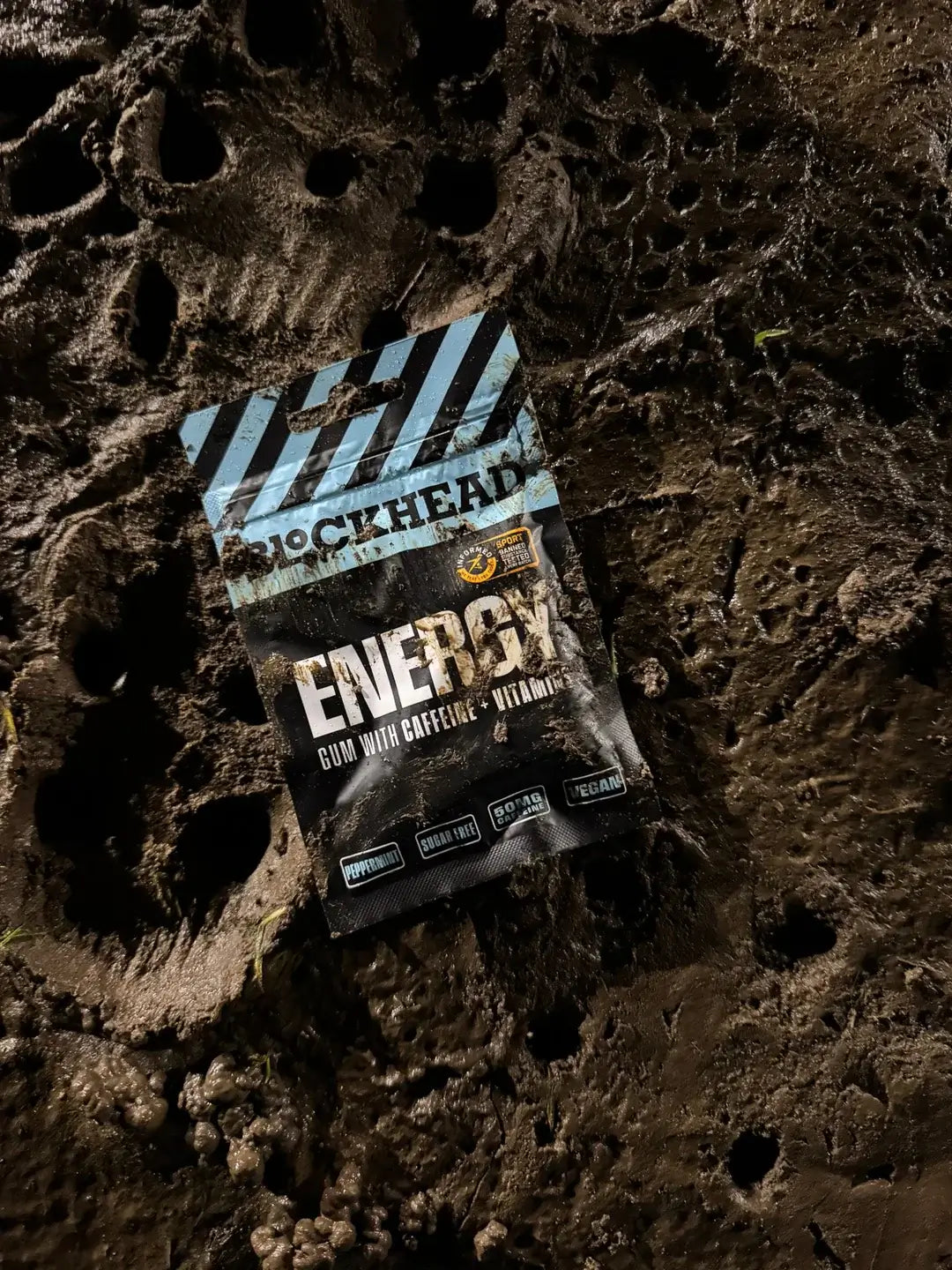 Blockhead Caffeine Gum packet on textured surface, featuring mint flavor, 50mg caffeine per piece, vegan and sugar-free.