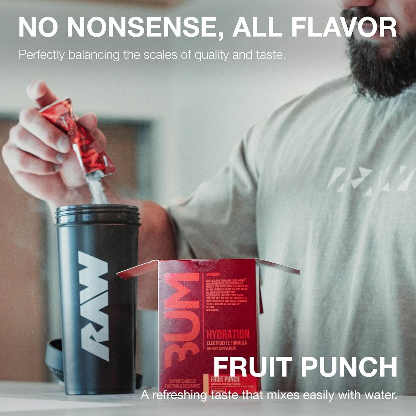 A person adding Raw Nutrition Bum Hydration to a shaker cup, promoting quick hydration and a refreshing fruit punch flavor.